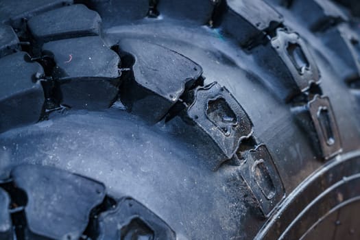 dark rough rubber truck tire, fragment