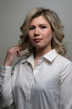 30 years old woman with blond hair in a white shirt posing in the studio