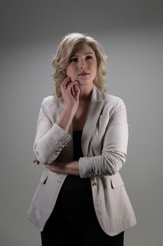 30 years old woman with blond hair in business clothes posing on a white background