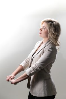 30 years old woman with blond hair in business clothes posing on a white background