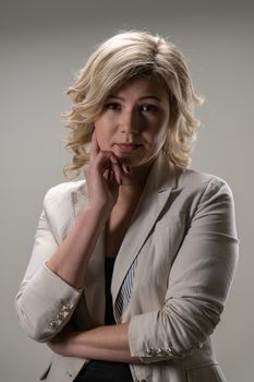 30 years old woman with blond hair in business clothes posing on a white background