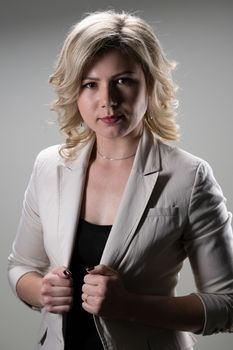 30 years old woman with blond hair in business clothes posing on a white background