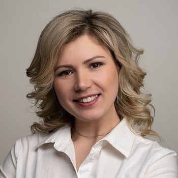 woman 30 years old with blond hair posing on a white background with a smile