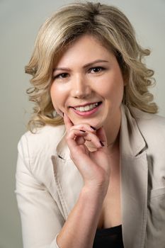 woman 30 years old with blond hair posing on a white background with a smile