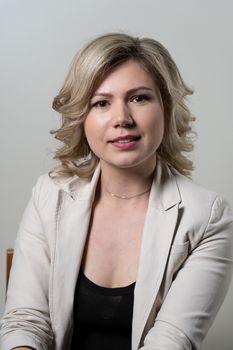 30 years old woman with blond hair posing on a white background