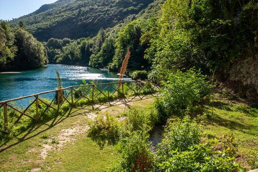 small stifone garden on the river with blue water