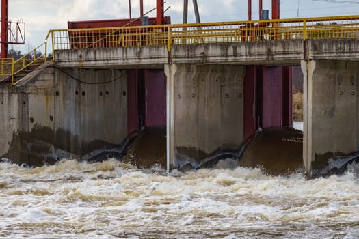 hydraulic structure, a dam through which a river flows, made of concrete and metal