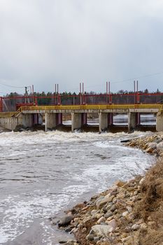 hydraulic structure, a dam through which a river flows, made of concrete and metal