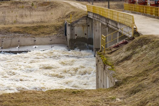 hydraulic structure, a dam through which a river flows, made of concrete and metal