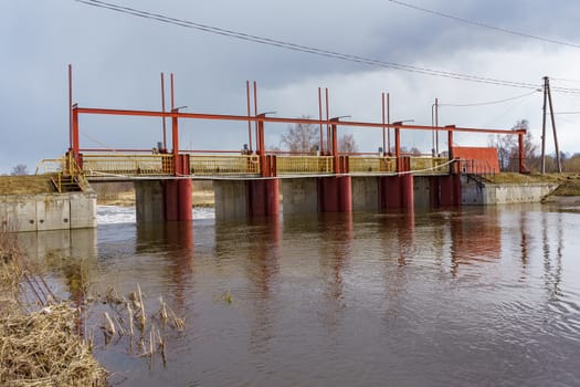 hydraulic structure, a dam through which a river flows, made of concrete and metal