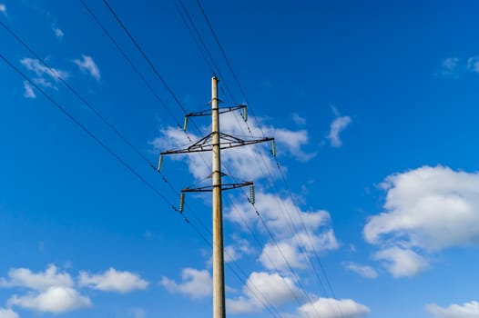 Power line and blue sky with white clouds.