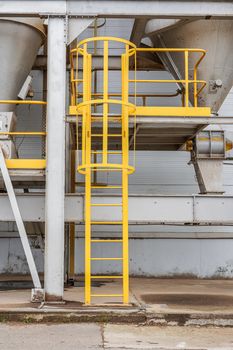fire safety elements on the wall of an industrial building: stairs, fences