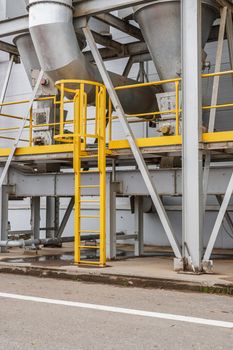 fire safety elements on the wall of an industrial building: stairs, fences