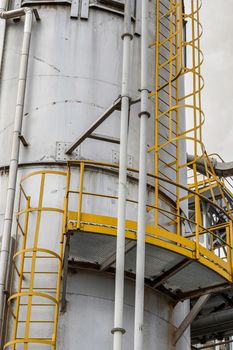 fire safety elements on the wall of an industrial building: stairs, fences