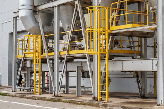 fire safety elements on the wall of an industrial building: stairs, fences, signs