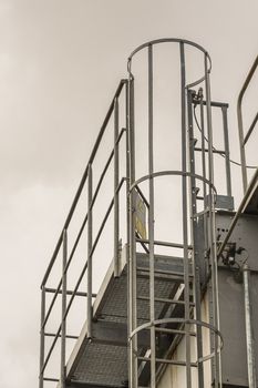 upper part of an industrial building with stairs, railings and other safety features