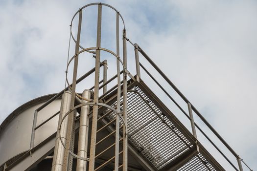 upper part of an industrial building with stairs, railings and other safety features