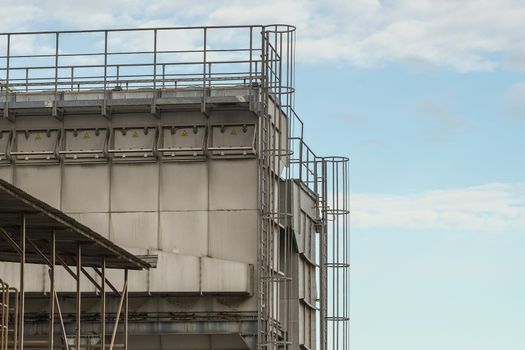 upper part of an industrial building with stairs, railings and other safety features