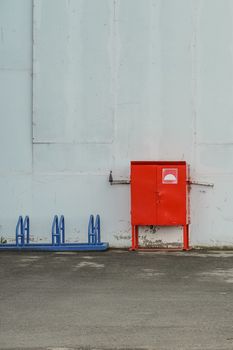 red box with fire-fighting materials at the entrance to an industrial building