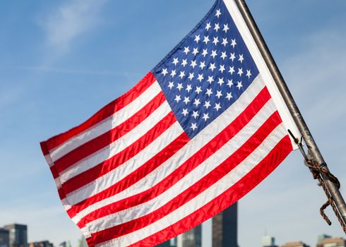 An American flag flies from a boat on the East River in New York City.