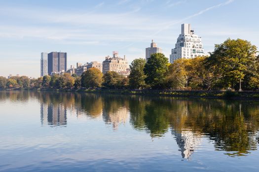 The view across the Jackie Onassis Reservoir in Central Park, New York City on a still autumn morning.