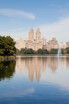 The view across the Jackie Onassis Reservoir in Central Park, New York City in the United States of America on a still autumn morning.