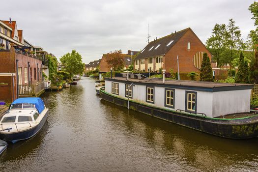 canal and different types of housing surrounding it in a suburb of the city of alkmaar netherlands holland