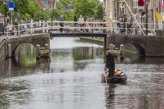 boat with cheeses in an alkmaar channel after having crossed one of the drawbridges netherlands holland