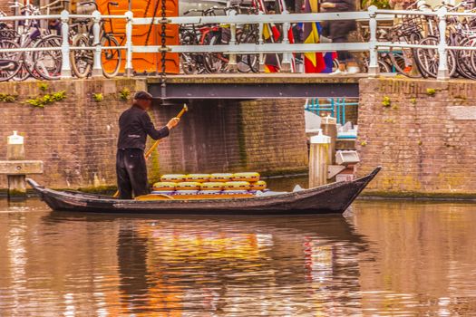 transporting cheeses for sale in the alkmaar channels. netherlands holland