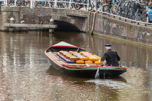 Great transport boat full of exquisite Dutch cheeses about to cross one of the many drawbridges. alkmaar netherlands holland