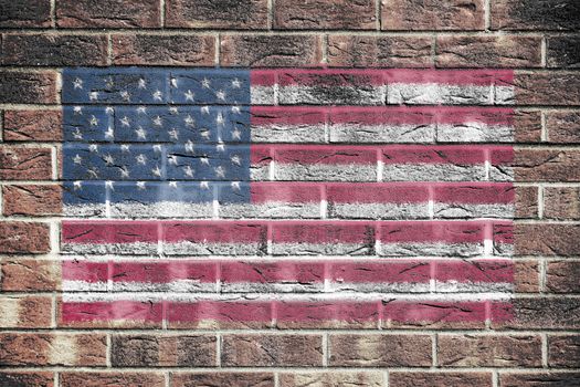 A United States of America flag stars and stripes old glory on brick wall background