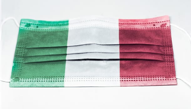 surgical mask with the national flag of Italy printed. Pandemic covid-19 and preventive measures to counter the spread of the virus