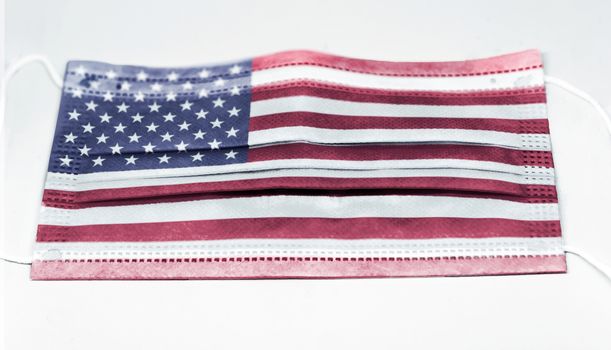 surgical mask with the USA national flag printed. Pandemic covid-19 and preventive measures to counter the spread of the virus