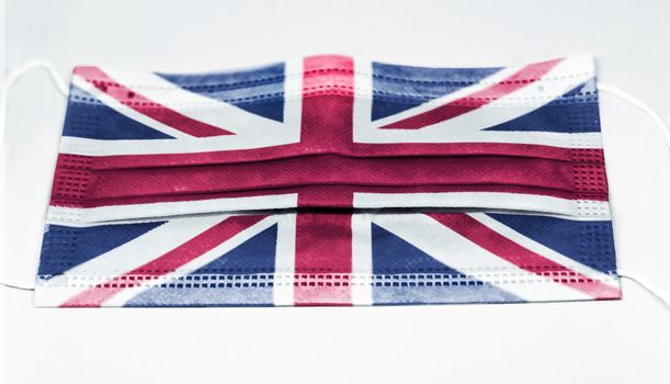 surgical mask with the national flag of England printed. Pandemic covid-19 and preventive measures to counter the spread of the virus