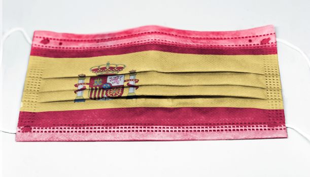 surgical mask with the national flag of Spain printed. Pandemic covid-19 and preventive measures to counter the spread of the virus