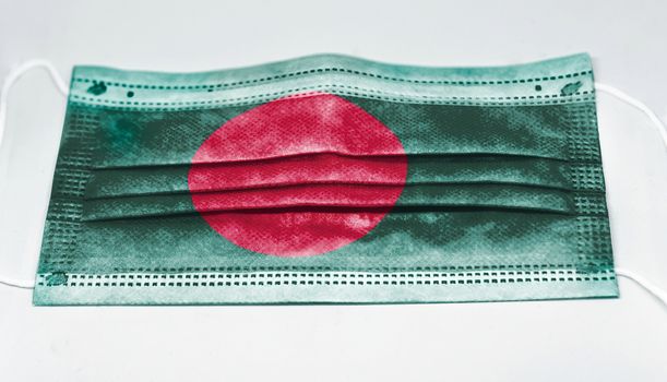 surgical mask with the national flag of Bangladesh printed. Pandemic covid-19 and preventive measures to counter the spread of the virus