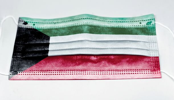 surgical mask with the national flag of Kuwait printed. Pandemic covid-19 and preventive measures to counter the spread of the virus