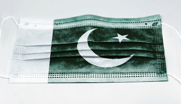 surgical mask with the national flag of Pakistan printed. Pandemic covid-19 and preventive measures to counter the spread of the virus