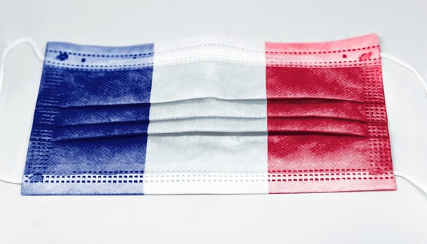 surgical mask with the national flag of France printed. Pandemic covid-19 and preventive measures to counter the spread of the virus