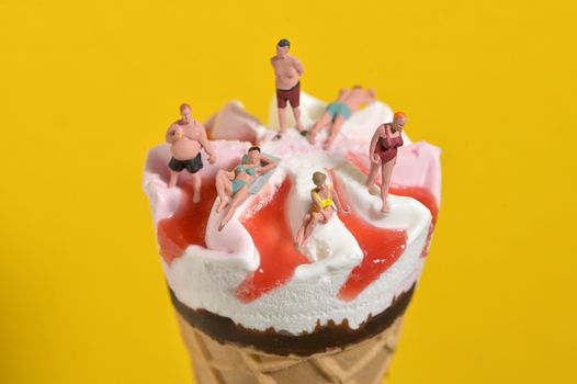 Ice Cream In Waffle Cone and Miniature People on Beach