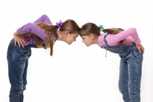 quarrel two girls standing leaning their foreheads against to each other