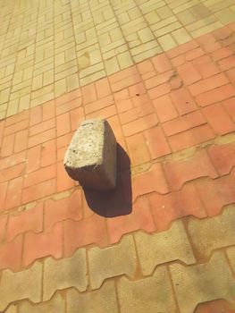 big stone with its shadow lying on the ground