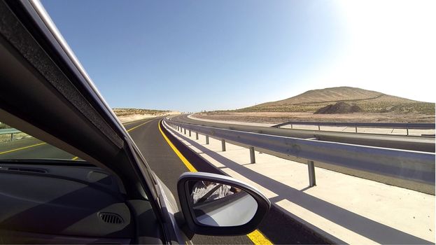 desert drive from car window - fuertaventura canary islands modern highway