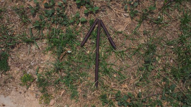 bush craft bushcraft stick arrow pointing up on grass and brown wooden sticks survival military sign signal