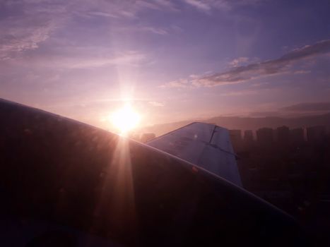 sunrise over an aeroplane wing flying