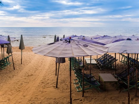 Colorful canvas daybed under the beach umbrella