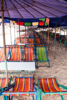 Colorful canvas daybed under the beach umbrella