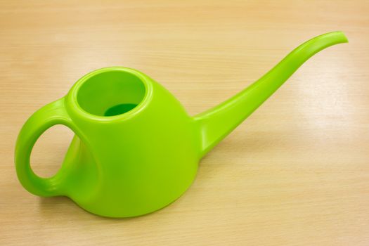 green watering can on woos table
