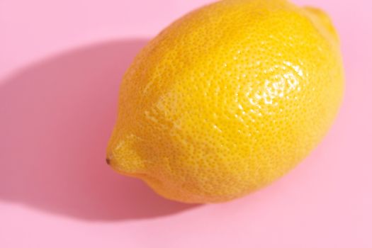 Trendy yellow lemon isometric pattern on pink background. Creative and modern minimal concept. Summer fresh flat lay food texture, copy space.