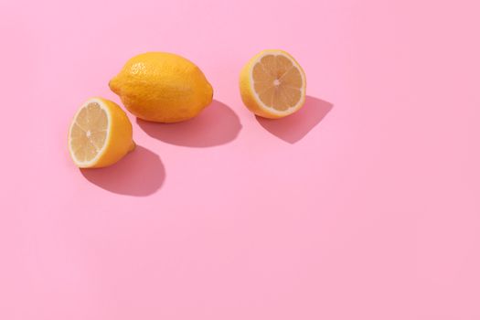 Trendy yellow lemon isometric pattern on pink background. Creative and modern minimal concept. Summer fresh flat lay food texture, copy space.
